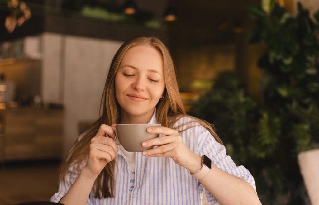 How to Maximize Your Dental Insurance Benefits After the 2026 Reset 1 Portrait of gorgeous blonde smiling lady smelling, enjoying of coffee and drinking cappuccino from cup while resting in restaurant. Woman wear stripped shirt.