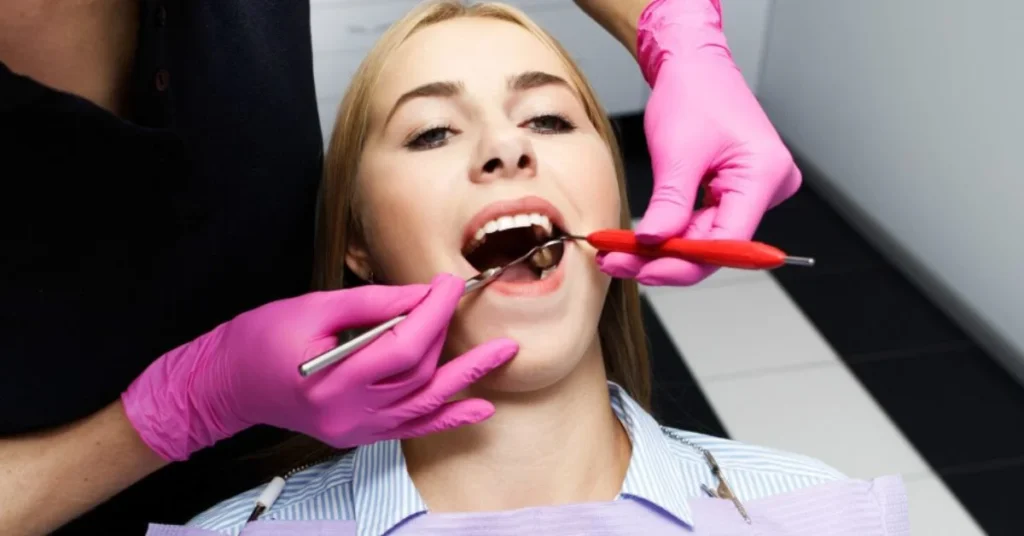 Dentist performing composite dental filling procedure in clinic