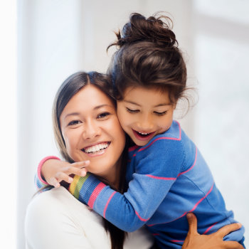 Happy mother hugging daughter Dunwoody Dental Health care